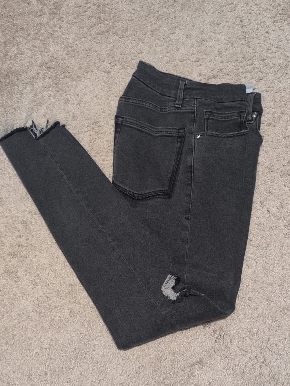 Good American Washed Black High-Rise Skinny Jeans with Knee Rip